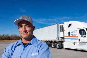 Truck driver standing in front of his truck