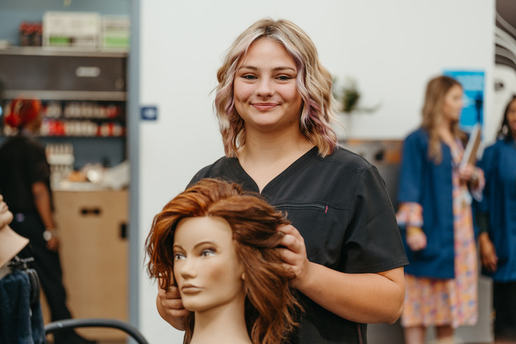 Student posing in Cosmetology lab