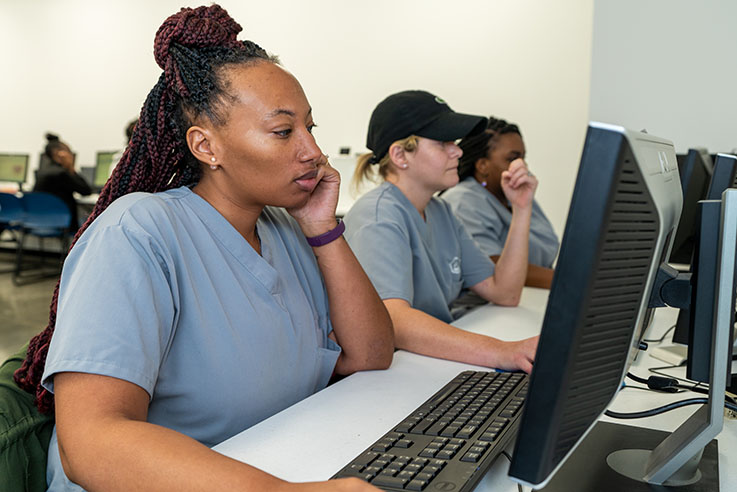 Female student sitting at PC